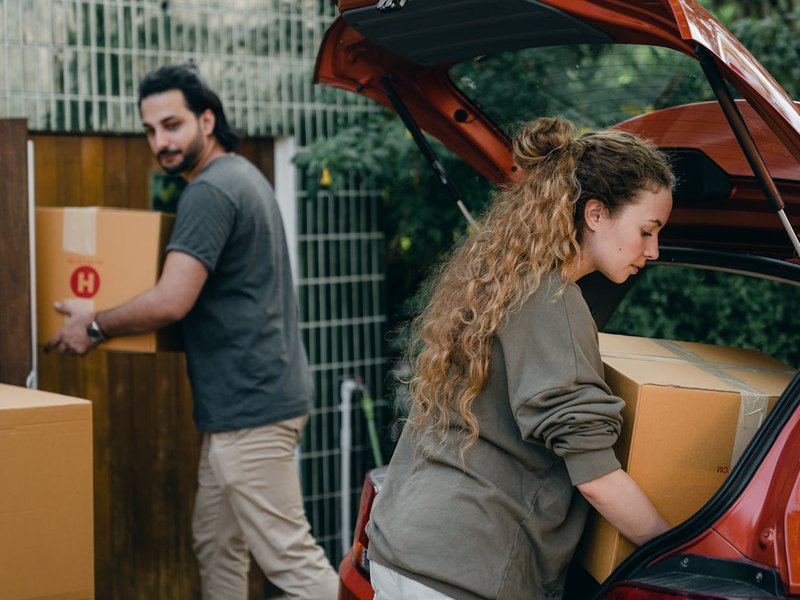 Sopko Moving crew carrying a wrapped sofa up front steps in Somerset County